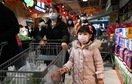 A family pushes a cart with vegetables at a supermarket in Beijing. (AFP) A family pushes a cart with vegetables at a supermarket in Beijing. (AFP)