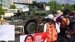 Protesters hold signs in front of an armoured vehicle during a demonstration against the military coup in front of the Central Bank of Myanmar in Yangon on February 15, 2021. (Photo by Sai Aung Main / AFP)(AFP) Protesters hold signs in front of an armoured vehicle during a demonstration against the military coup in front of the Central Bank of Myanmar in Yangon on February 15, 2021. (Photo by Sai Aung Main / AFP)(AFP)