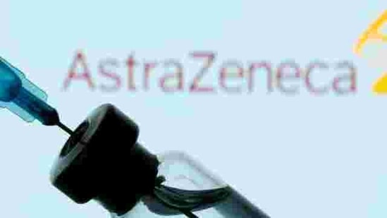A vial and sryinge are seen in front of a displayed AstraZeneca logo in this illustration. (Reuters)