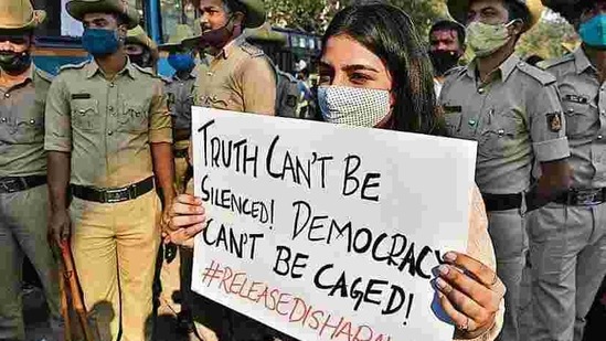 A woman holding a placard during a protest against the arrest of climate activist Disha Ravi in Bengaluru.(Reuters) A woman holding a placard during a protest against the arrest of climate activist Disha Ravi in Bengaluru.(Reuters)
