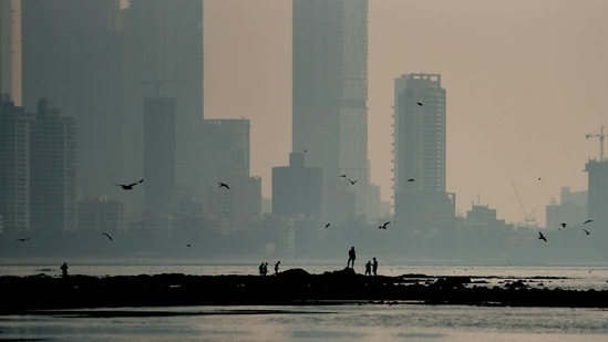 Visitors at Mahim beach on a hazy day in Mumbai on February 12. Mumbai on February 14 reported over 600 cases after 31 days with 645 fresh infections. The city last saw over 600 cases in a day on January 14, HT reported.(Satish Bate / HT Photo)