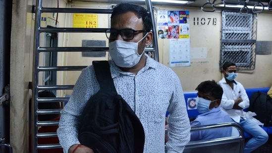 Rakesh Patil, a passenger, commutes on a local train, at Thane on February 11. Health experts have attributed the rise in cases to the increase in movement of people post the resumption of local trains in Mumbai and Mumbai Metropolitan Region (MMR), HT reported(Praful Gangurde / HT Photo)