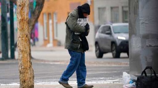 A man holds his sign asking for help while bundled up against a single-digit daytime high temperature as a cold front fueled by the Arctic vortex grips the region Saturday, Feb. 13, 2021, in Denver. (AP Photo) A man holds his sign asking for help while bundled up against a single-digit daytime high temperature as a cold front fueled by the Arctic vortex grips the region Saturday, Feb. 13, 2021, in Denver. (AP Photo)