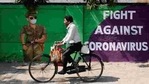 A man cycles past a graffiti-covered wall amidst the spread of the coronavirus disease (COVID-19) on a street in Navi Mumbai.(Francis Mascarenhas/REUTERS) A man cycles past a graffiti-covered wall amidst the spread of the coronavirus disease (COVID-19) on a street in Navi Mumbai.(Francis Mascarenhas/REUTERS)