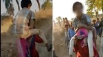 Screenshot of the woman being forced to carry a teenage boy on her shoulders. (Sourced) Screenshot of the woman being forced to carry a teenage boy on her shoulders. (Sourced)