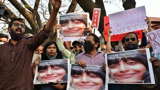 People hold placards during a protest against the arrest of climate activist Disha Ravi, in Bengaluru, India. (Reuters)