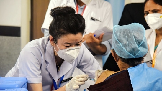 A health worker receives a Covid-19 vaccine shot, at AIIMS in New Delhi. A health worker receives a Covid-19 vaccine shot, at AIIMS in New Delhi.