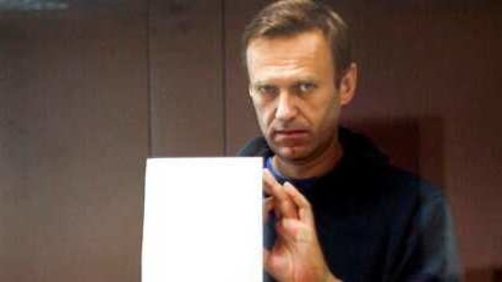 In this photo taken from a footage provided by the Babuskinsky District Court Tuesday, Feb. 16, 2021, Russian opposition leader Alexei Navalny writes notes as he stands in a cage during a hearing on his charges for defamation in the Babuskinsky District Court in Moscow, Russia. Navalny is accused of defaming a World War II veteran who was featured in a video last year advertising constitutional amendments that allowed an extension of President Vladimir Putin's rule. (Babuskinsky District Court Press Service via AP)(AP)