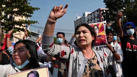 Demonstrators hold placards and raise slogans during the ongoing protest against the military coup in Yangon on February 15. The protests are taking place in defiance of an order banning gatherings of five or more people, AP reported.(REUTERS)
