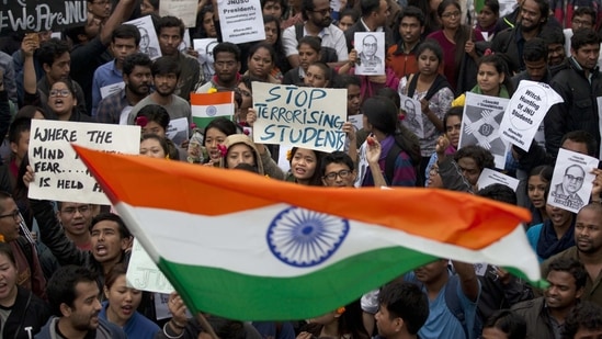 Students wave the national flag and shout slogans during a protest at the Jawaharlal Nehru University against the arrest of a student union leader in New Delhi(AP Photo) Students wave the national flag and shout slogans during a protest at the Jawaharlal Nehru University against the arrest of a student union leader in New Delhi(AP Photo)
