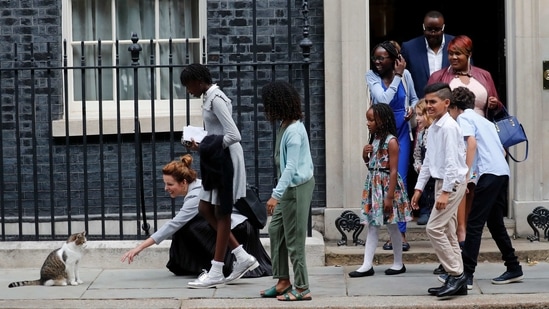 School children approach Downing Street Chief Mouser Larry the cat, as they leave after a scheduled meeting with Britain's Prime Minister Boris Johnson on August 30, 2019. Visitors to the building can sometimes find him napping on a ledge above a radiator or sleeping on a floor, where dignitaries occasionally have to step over him.(Frank Augstein / AP)