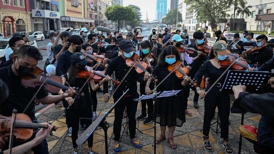 Demonstrators perform classical music during the ongoing protest against the military coup in Yangon on February 16.(Ye Aung Thu / AFP)