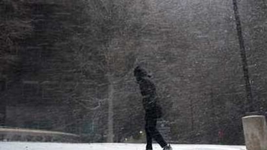 A woman walks through falling snow in San Antonio, Sunday, Feb. 14, 2021. Snow and ice blanketed large swaths of the U.S. on Sunday, prompting canceled flights, making driving perilous and reaching into areas as far south as Texas’ Gulf Coast, where snow and sleet were expected overnight. (AP Photo/Eric Gay) (AP) A woman walks through falling snow in San Antonio, Sunday, Feb. 14, 2021. Snow and ice blanketed large swaths of the U.S. on Sunday, prompting canceled flights, making driving perilous and reaching into areas as far south as Texas’ Gulf Coast, where snow and sleet were expected overnight. (AP Photo/Eric Gay) (AP)