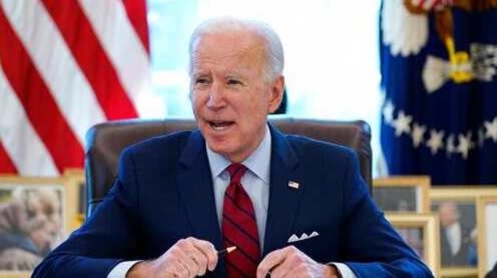 FILE - In this Jan. 28, 2021 file photo, President Joe Biden signs a series of executive orders in the Oval Office of the White House in Washington. Biden campaigned on raising the national minimum wage to $15 per hour and attached a proposal doing just that to the $1.9 trillion coronavirus pandemic relief bill. (AP Photo/Evan Vucci) (AP)
