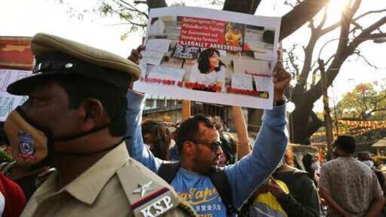 A man holds a placard demanding the release of Indian climate activist Disha Ravi, during a protest in Bengaluru, India, Monday, Feb.15, 2021. (AP)