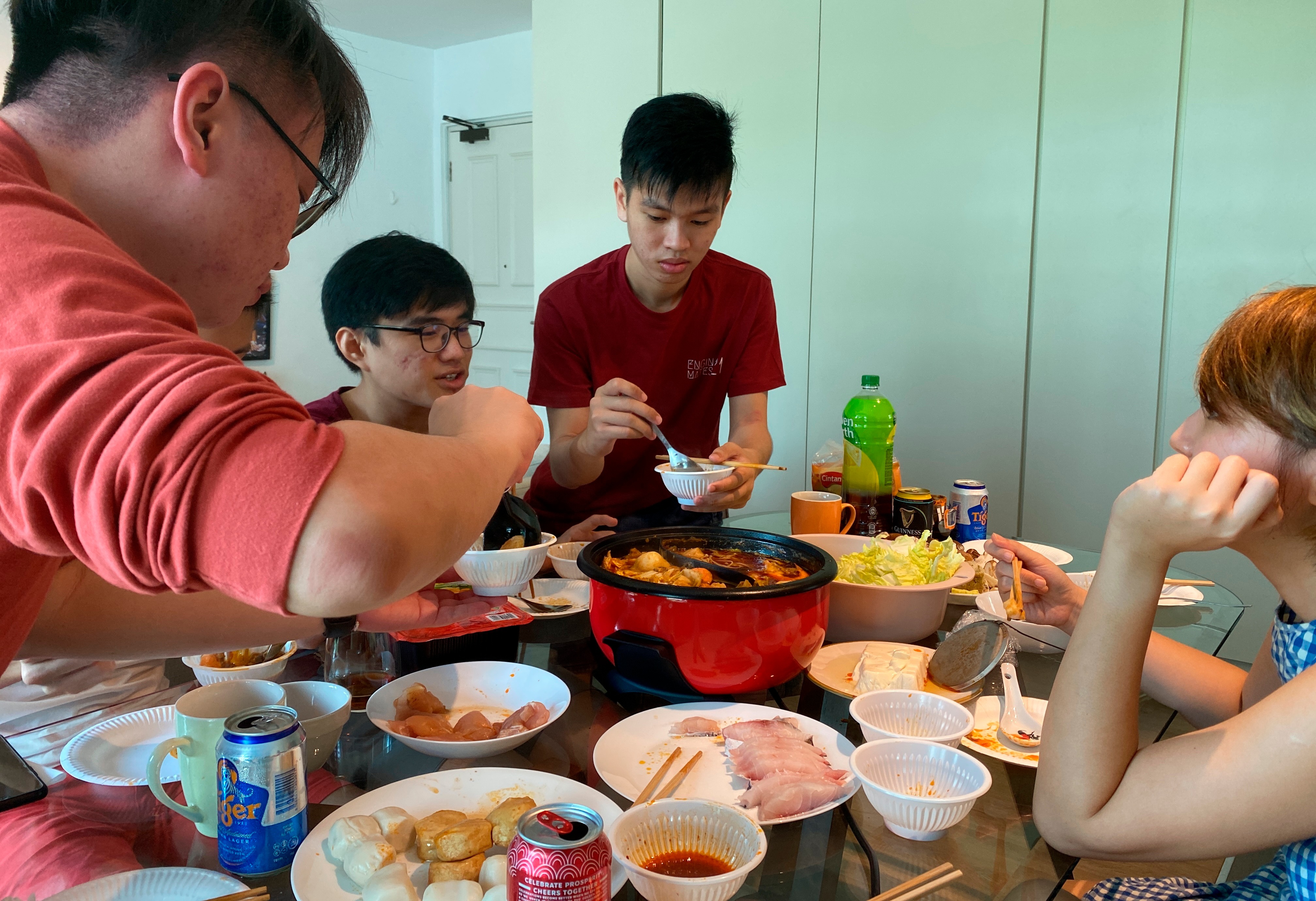 Malaysian students enjoy a Lunar New Year hot pot lunch provided by their host.(AP) Malaysian students enjoy a Lunar New Year hot pot lunch provided by their host.(AP)