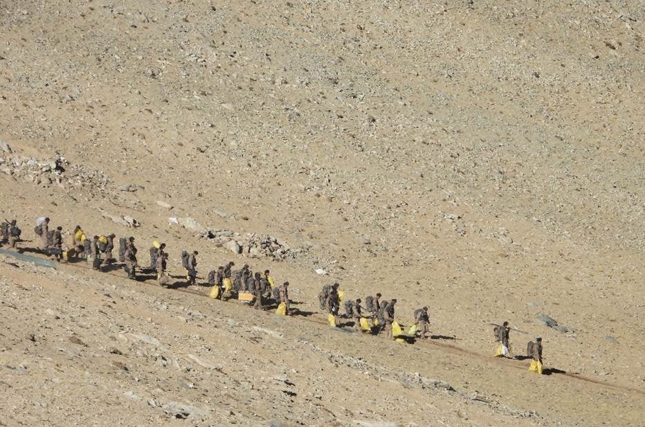 Soldiers with equipment and rucksacks move to rear areas (SOURCED/Indian Army/Rahul Singh)