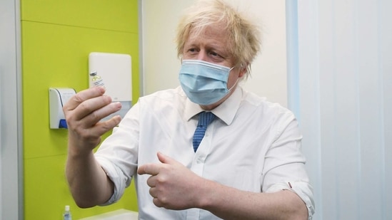 Britain's Prime Minister Boris Johnson holds a vial of Astra Zeneca coronavirus disease (COVID-19) vaccine during a visit to a coronavirus vaccination centre at the Health and Well-being Centre in Orpington, South-East of London, Britain February 15, 2021. Jeremy Selwyn/Pool via REUTERS(REUTERS)
