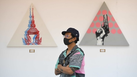 "Headache Stencil", a graffiti artist, poses in front of his works during his "112 the Exhibition" at WTF Gallery and Cafe in Bangkok, Thailand,  (REUTERS)