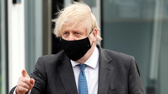 Britain's Prime Minister Boris Johnson gestures as he walks with police officers (not pictured) during his visit to South Wales Police Headquarters in Bridgend, South Wales, Britain February 17, 2021. Alastair Grant/Pool via REUTERS(REUTERS)