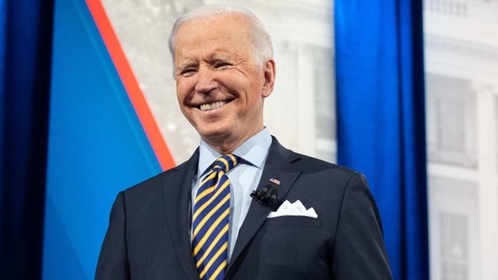 TOPSHOT - US President Joe Biden holds a face mask as he participates in a CNN town hall at the Pabst Theater in Milwaukee, Wisconsin, February 16, 2021. (Photo by SAUL LOEB / AFP)(AFP)