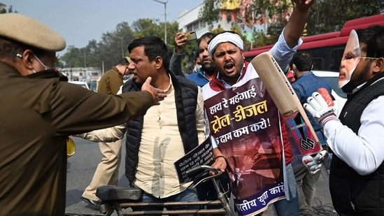 Activists of Indian youth Congress (IYC) stop traffic during a protest against the recent petrol and diesel price hike, in New Delhi on February 17, 2021. (Photo by Money SHARMA / AFP)(AFP)