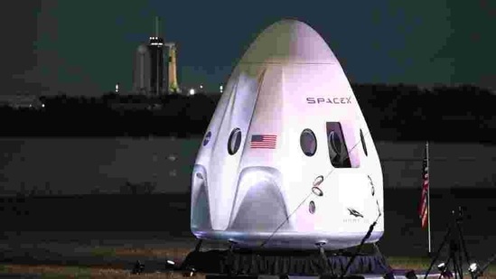 A full-size model of the Crew-1 spacecraft module sits near the launch pad as a SpaceX Falcon 9 rocket is seen at launch complex 39A in the background at the Kennedy Space Center in Florida on November 15. SpaceX’s newly designed Crew Dragon capsule, which the crew has dubbed Resilience, lifted off atop a SpaceX Falcon 9 rocket at 7:27 p.m. eastern time (0027 GMT on November 15), Reuters reported. (Gregg Newton / AFP)