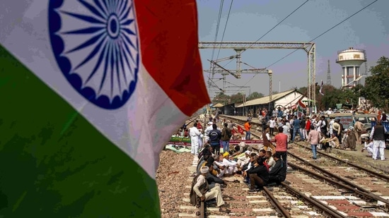 Farmers sitting on railway track to stop trains as part of protests against farm laws, in Sonipat, Haryana on February 18. After the Republic Day tractor rally and a 'chakka jaam' blockade on February 6, the 'rail roko' is the third major protest by the farmers in their continued agitation against the three farm laws.(Danish Siddiqui / REUTERS)