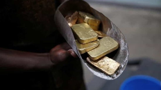 An employee holds gold bars before the refining process at AGR (African Gold Refinery) in Entebbe, Uganda. (Reuters File Photo )