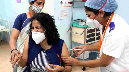 A nurse administers the Covid-19 vaccine to the frontline workers after the virtual launch of the Covid-19 vaccination drive. (ANI Photo )