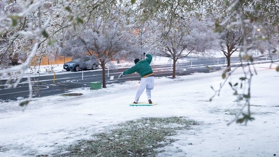 A man slides down an icy hill in Austin, Texas, US on Wednesday. The crisis has knocked out power for days to millions of homes and businesses in Texas and across the central US. (Bloomberg Photo )