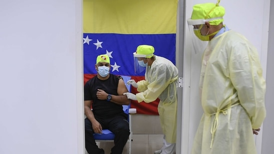 A healthcare worker administers a dose of the Russian Sputnik V Covid-19 vaccine at a health clinic in Caracas, Venezuela.(Bloomberg) A healthcare worker administers a dose of the Russian Sputnik V Covid-19 vaccine at a health clinic in Caracas, Venezuela.(Bloomberg)
