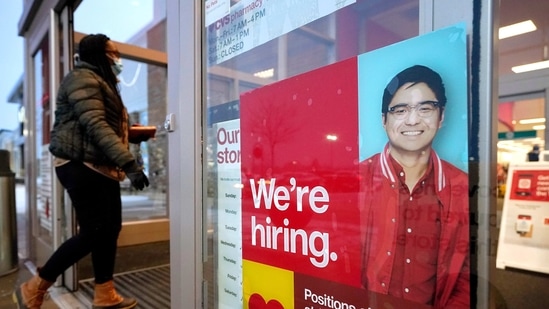 A passer-by walks past an employment hiring sign while entering a Target store location in Westwood, Massachusetts. (AP) A passer-by walks past an employment hiring sign while entering a Target store location in Westwood, Massachusetts. (AP)