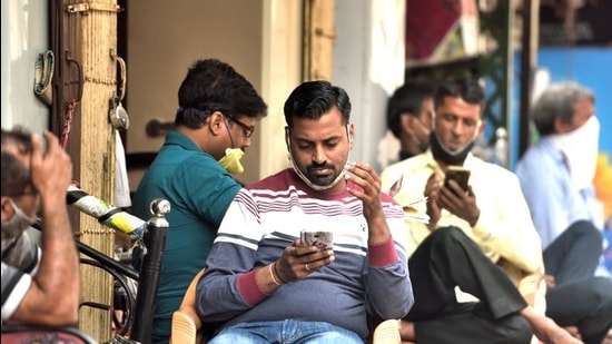People sitting with their masks pulled down at Chembur market in Mumbai on Thursday. (Satish Bate/HT Photo) People sitting with their masks pulled down at Chembur market in Mumbai on Thursday. (Satish Bate/HT Photo)
