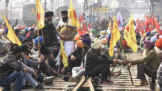 A large number of demonstrators at a railway station in Amritsar on February 18. Protesting farmers have expressed apprehension that the new laws would pave the way for eliminating the safety cushion of Minimum Support Price and do away with the mandis, leaving them at the mercy of big corporates.(Narinder Nanu / AFP)