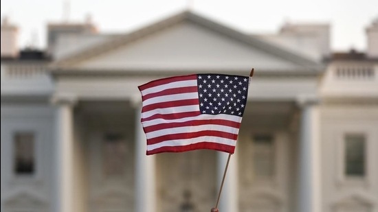 A flag is waved outside the White House, in Washington. (AP)