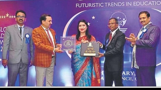 School principal Reema Tandon, centre, receiving the award from CBSE secretary Anurag Tripathi , second from left, during the 6th Edu-leaders Annual Conference which was held in Gurgaon