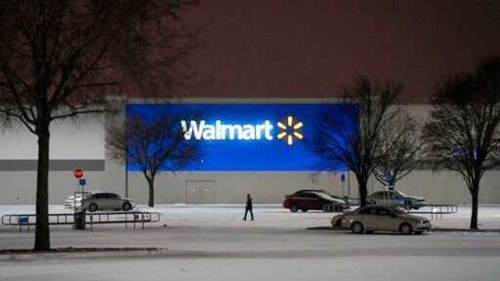 The parking lot of a Walmart Store on Coit Road empties as a second winter storm brought more snow and continued freezing temperatures to North Texas on Tuesday night, Feb. 16, 2021, in Plano, Texas. Walmart announced on Tuesday the chain would be closing 415 stores in Texas due to the weather. (Smiley N. Pool/The Dallas Morning News via AP)(AP)