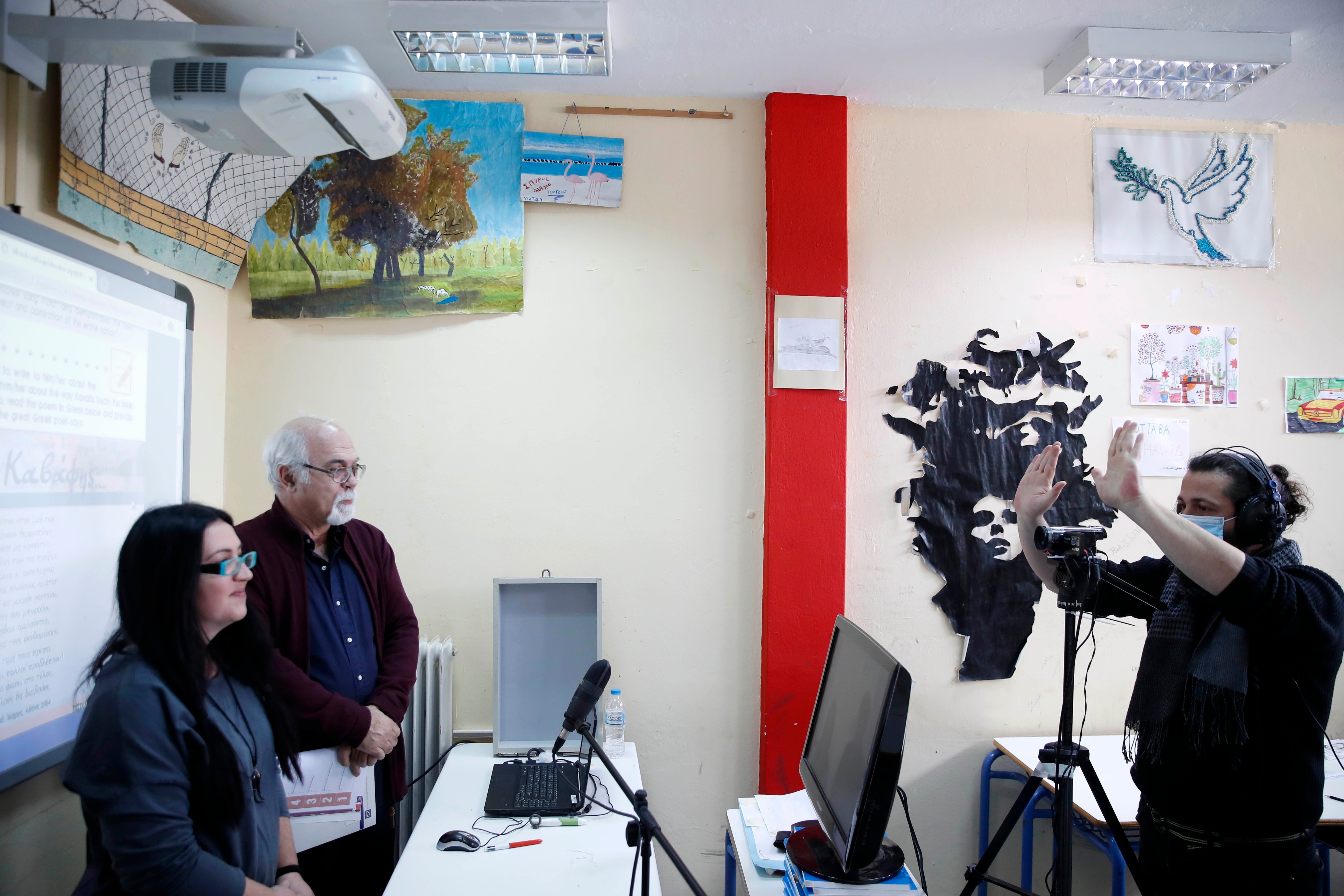 Music teacher, Nikos Karadosidis, right, gives directions to prison school director Petros Damianos and English teacher Sofia Samara before recording lessons at a classroom of Avlonas prison school.(AP) Music teacher, Nikos Karadosidis, right, gives directions to prison school director Petros Damianos and English teacher Sofia Samara before recording lessons at a classroom of Avlonas prison school.(AP)