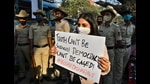 A woman holds a placard next to policemen during a protest against the arrest of climate activist Disha Ravi, Bengaluru, February 15, 2021 (REUTERS) A woman holds a placard next to policemen during a protest against the arrest of climate activist Disha Ravi, Bengaluru, February 15, 2021 (REUTERS)