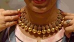 A saleswoman displays a gold necklace to a customer inside a jewellery showroom in Mumbai.(Reuters) A saleswoman displays a gold necklace to a customer inside a jewellery showroom in Mumbai.(Reuters)