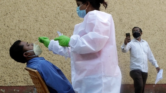 A health worker collects swab samples to test for COVID-19 in Mumbai, India, Friday, Feb. 19, 2021. (AP Photo/Rajanish Kakade)(AP)