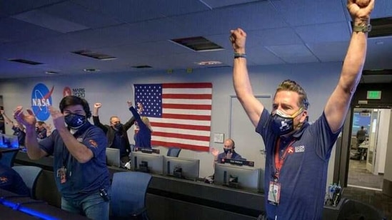 Members of NASA’s Perseverance rover team react in mission control after receiving confirmation the spacecraft successfully touched down on Mars.(via REUTERS)