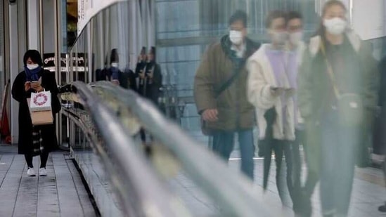 FILE PHOTO: Pedestrians wearing protective masks amid the coronavirus disease (COVID-19) outbreak, walk on a street in Tokyo, Japan, February 2, 2021. REUTERS/Kim Kyung-Hoon/File Photo (REUTERS)