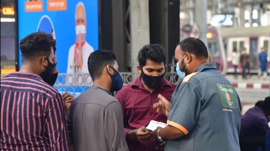 BMC officials fine citizens for violating Covid-19 norms at CSMT on Friday. (Bhushan Koyande/ HT) BMC officials fine citizens for violating Covid-19 norms at CSMT on Friday. (Bhushan Koyande/ HT)