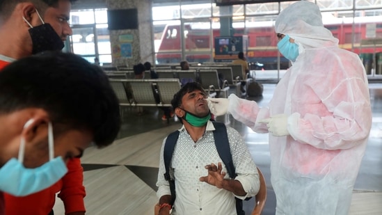 A health worker takes a swab sample of a passenger at Bandra train station in Mumbai, India, Wednesday, Feb. 17, 2021. Health officials have detected a spike in COVID-19 cases in several pockets of Maharashtra state, including in Mumbai, the country's financial capital. (AP Photo/Rafiq Maqbool) (AP) A health worker takes a swab sample of a passenger at Bandra train station in Mumbai, India, Wednesday, Feb. 17, 2021. Health officials have detected a spike in COVID-19 cases in several pockets of Maharashtra state, including in Mumbai, the country's financial capital. (AP Photo/Rafiq Maqbool) (AP)