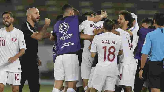 Qatar's head coach Felix Sanchez, second left, celebrates with players during the AFC Asian Cup quarter-final match against Korea Republic.(AP)