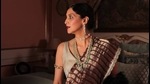 Srimoyi Bhattacharya wears a garnet red metallic saree with silver gold missing stripe pattern with a Chanel belt (Photo: Instagram/Pranay_Baidya) Srimoyi Bhattacharya wears a garnet red metallic saree with silver gold missing stripe pattern with a Chanel belt (Photo: Instagram/Pranay_Baidya)