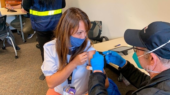Grace John, who works at a school in San Lorenzo, gets a Covid-19 shot in Hayward, California, on Friday.(AP) Grace John, who works at a school in San Lorenzo, gets a Covid-19 shot in Hayward, California, on Friday.(AP)