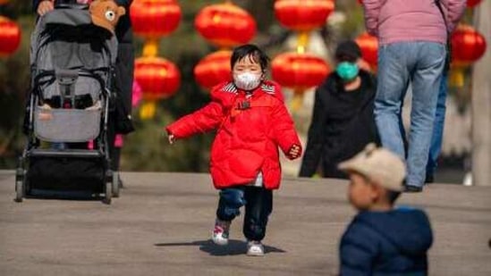 A child wearing a face mask to protect against the spread of the coronavirus runs along a path at a public park in Beijing, Friday, Feb. 19, 2021. (AP) A child wearing a face mask to protect against the spread of the coronavirus runs along a path at a public park in Beijing, Friday, Feb. 19, 2021. (AP)